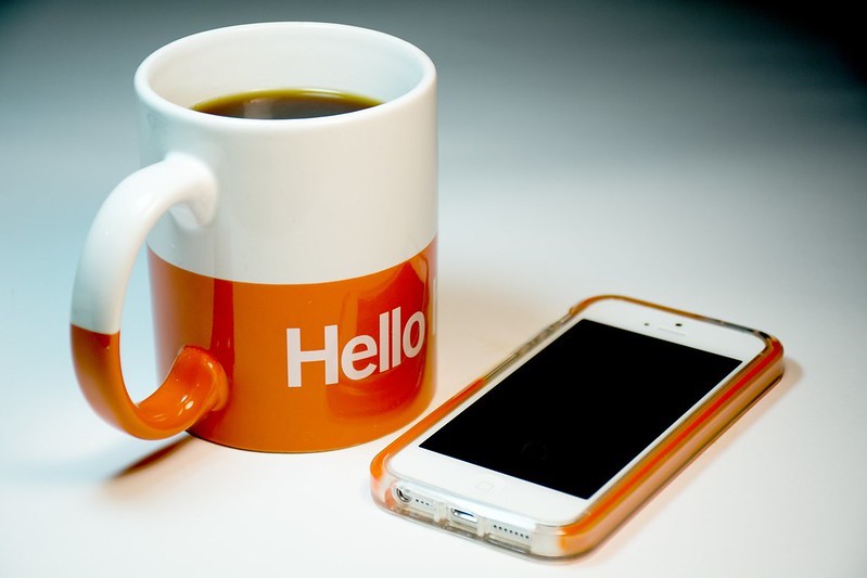 Coffee mug and smartphone on a table