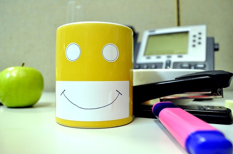 A yellow mug with a happy face