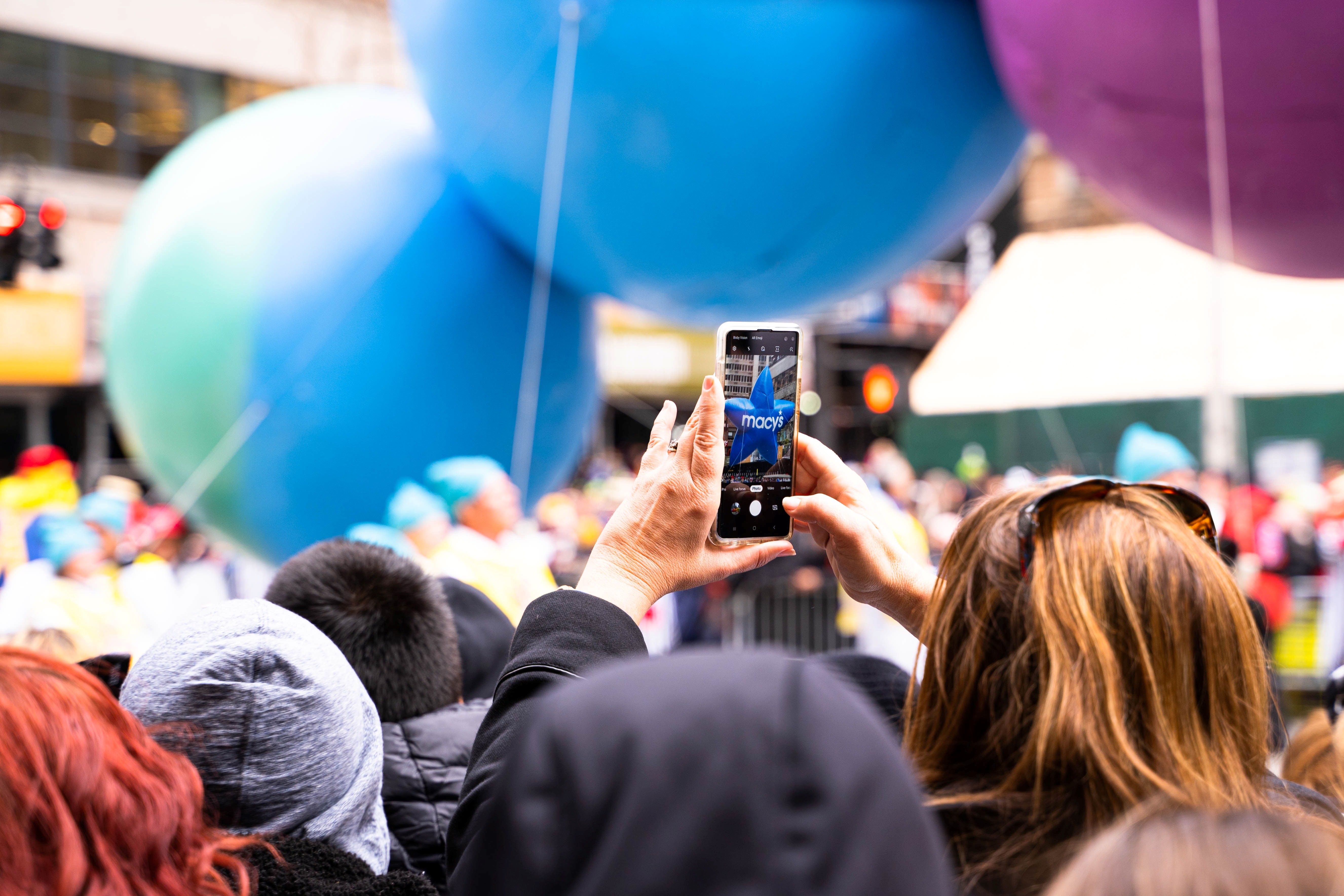 Person taking photo of event with mobile phone