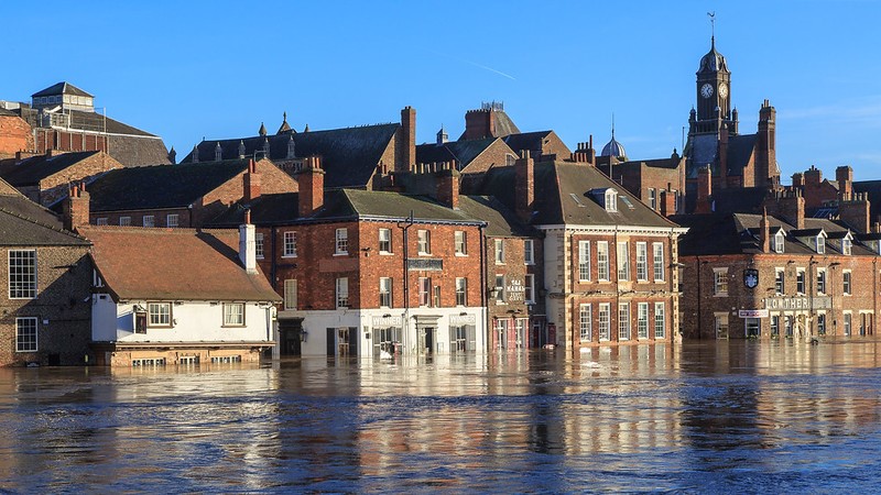 A cluster of houses or buildings submerged in a flood