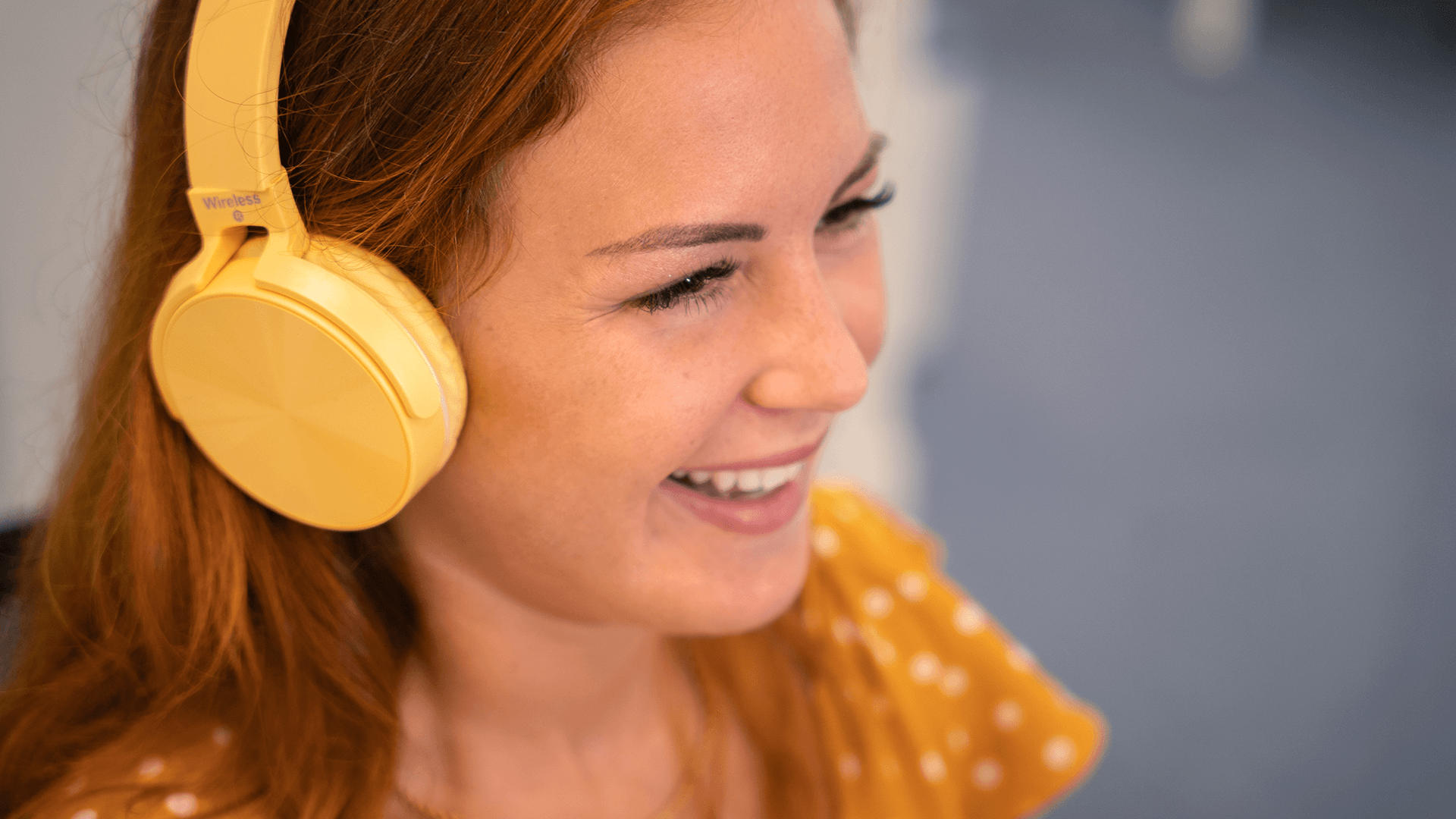 woman with yellow headset smiling